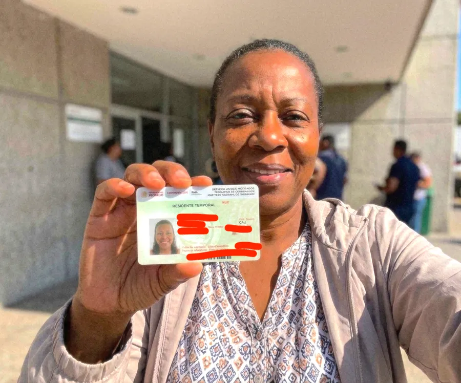 Reloca client holding her Mexico resident card