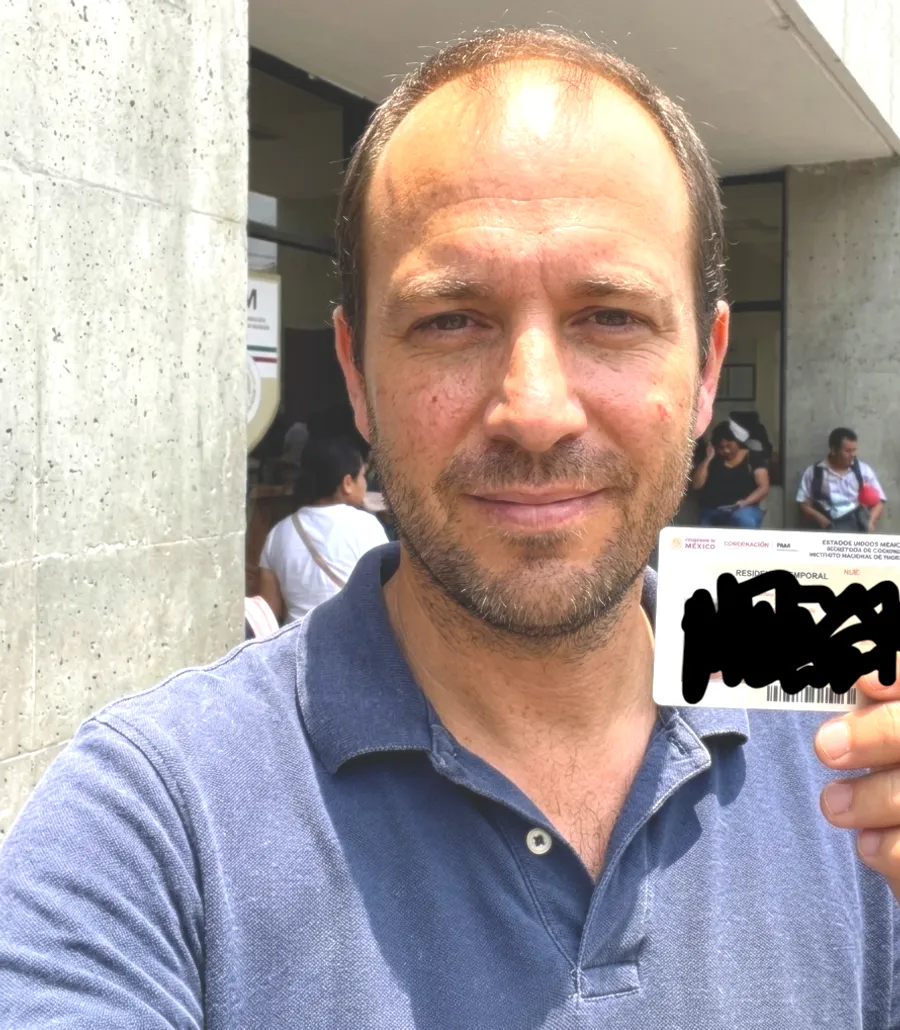 Reloca client holding his Mexico resident card